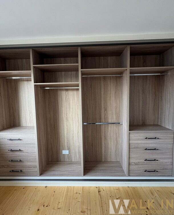 4-Door Sliding Wardrobe In Banna West, Co. Kerry 5 Spacious Wooden Wardrobe With Sliding Doors And Multiple Compartments In A Bedroom.